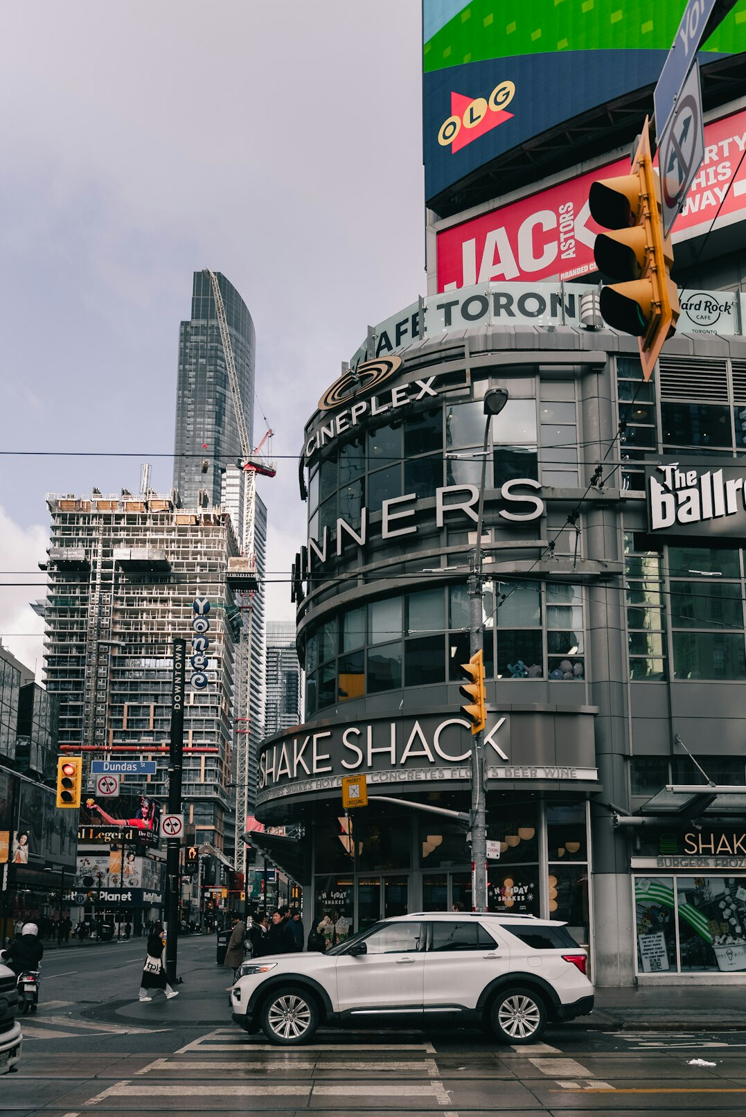 Pedestrians crossing a busy downtown Toronto street